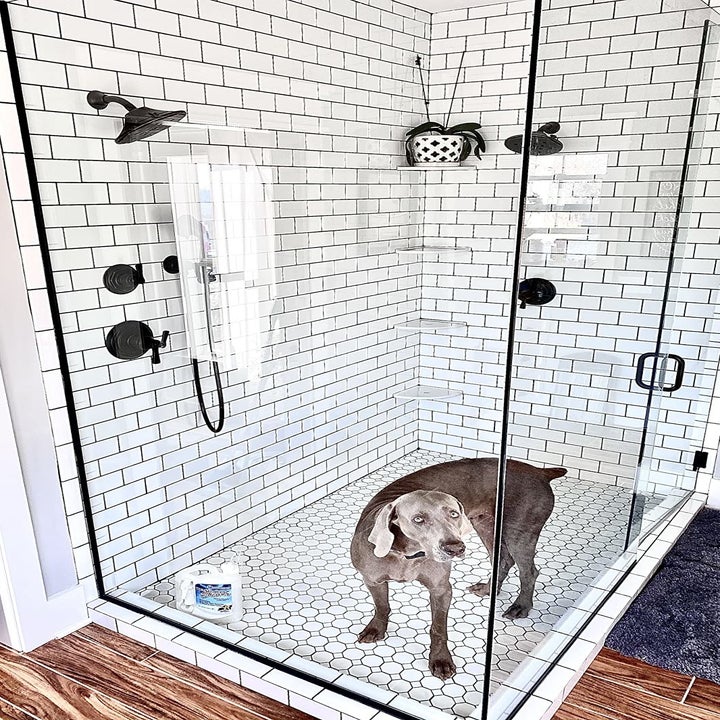 a reviewer photo of a sparkling clean shower with glass doors 