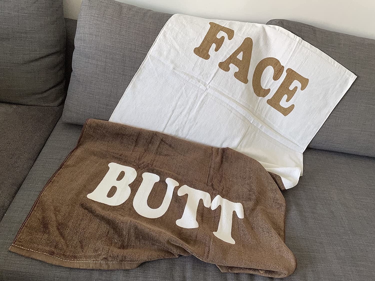 towel with brown and white sections that say face and butt