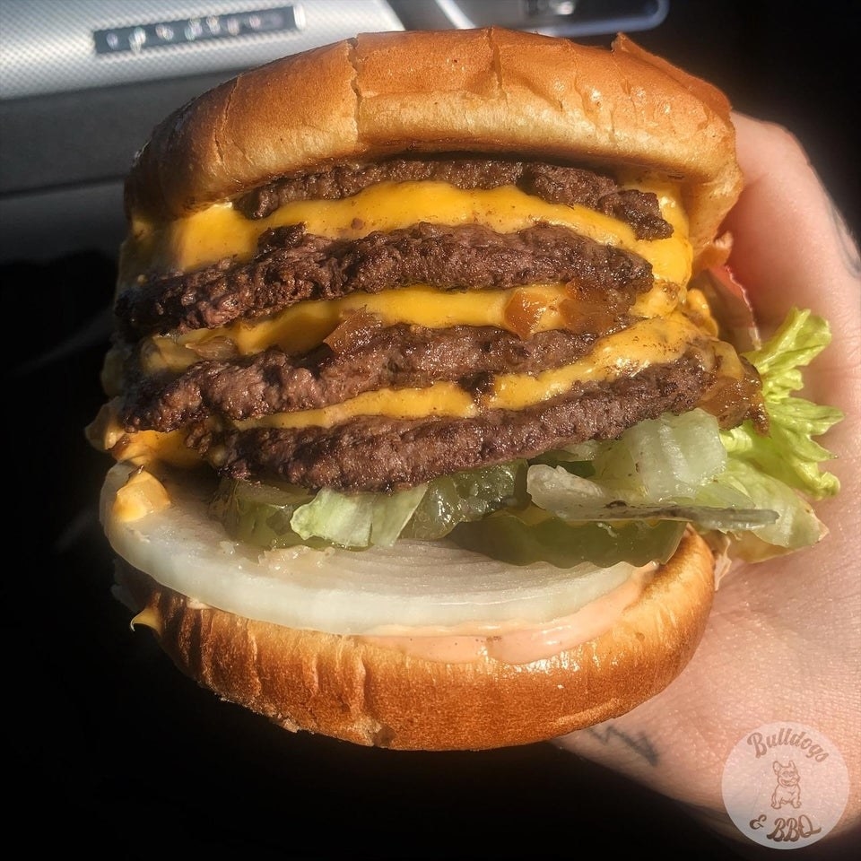 An In-N-Out Burger with four patties and four slices of cheese.