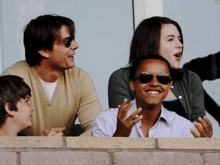 Bella sits in the crowd at a soccer game with Tom and her brother, Connor, many years ago