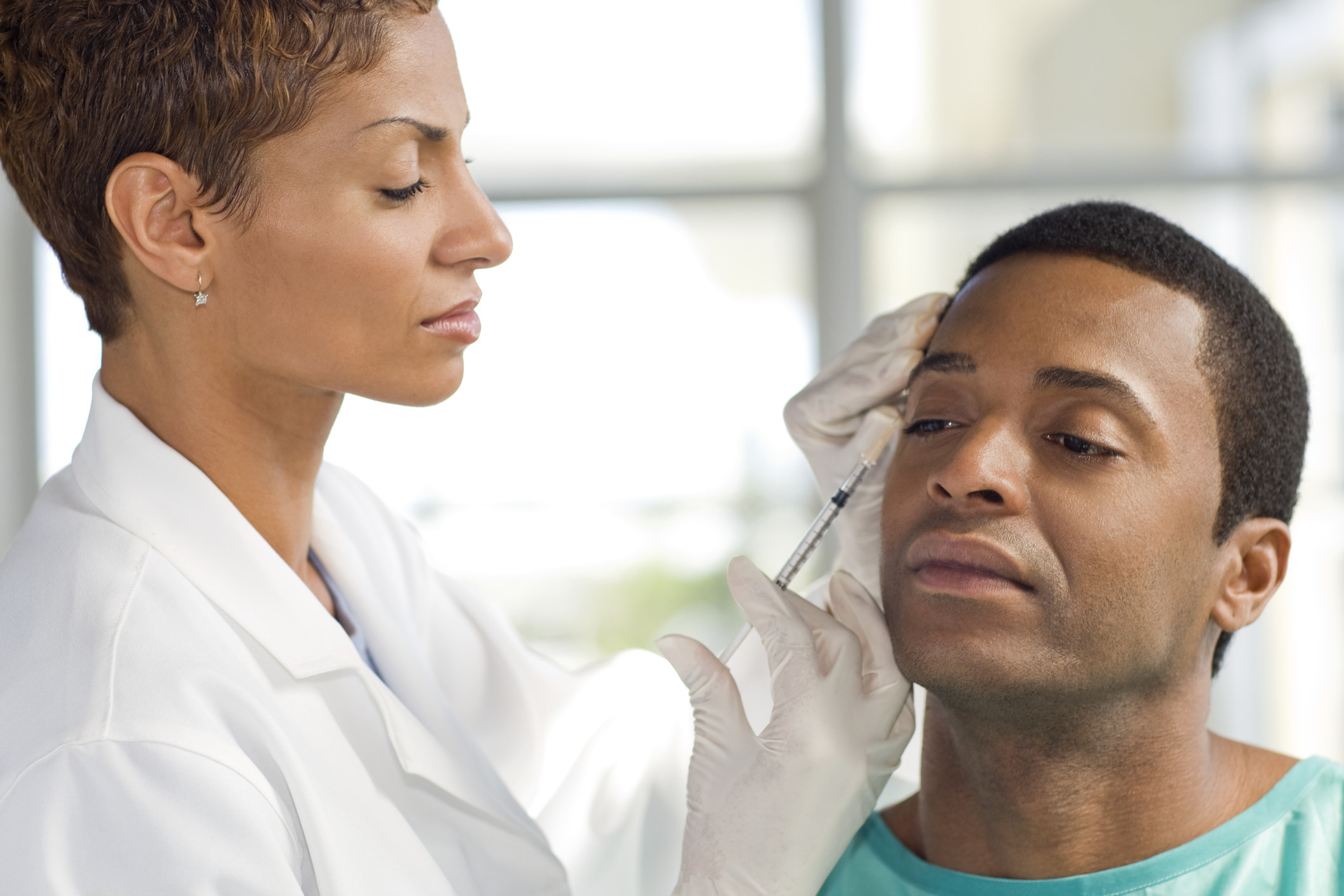 A doctor giving a man Botox injections