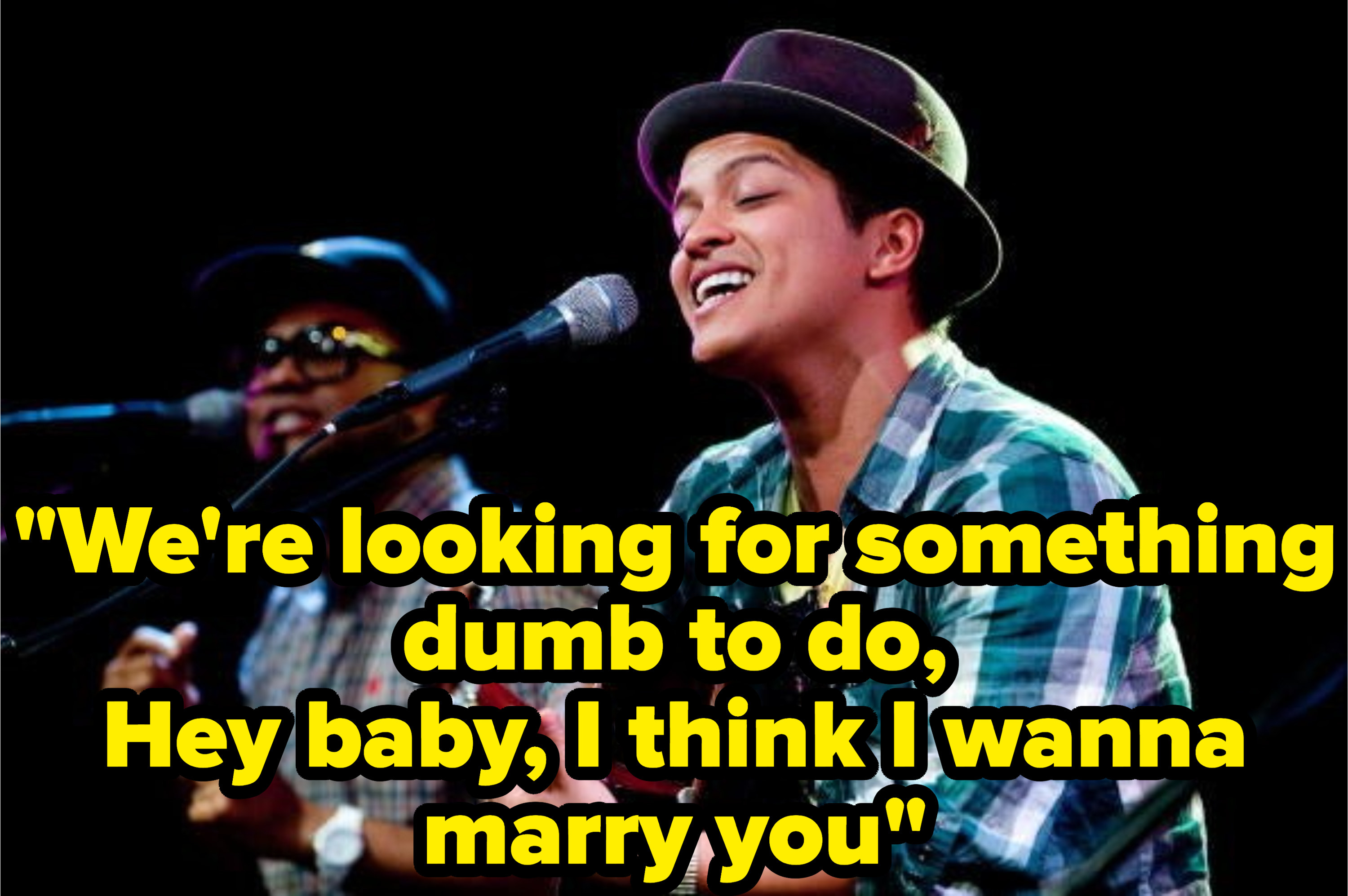 Still from the music video with the lyric: &quot;We&#x27;re looking for something dumb to do, Hey baby, I think I wanna marry you&quot;