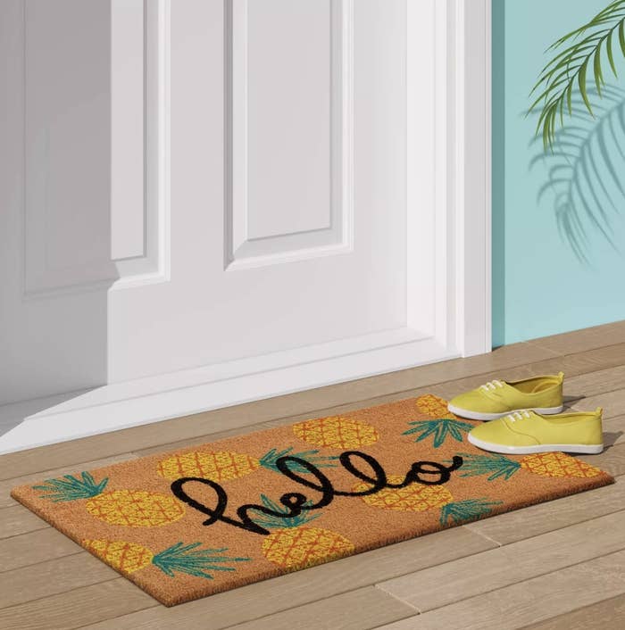 the welcome mat with yellow pineapples on it