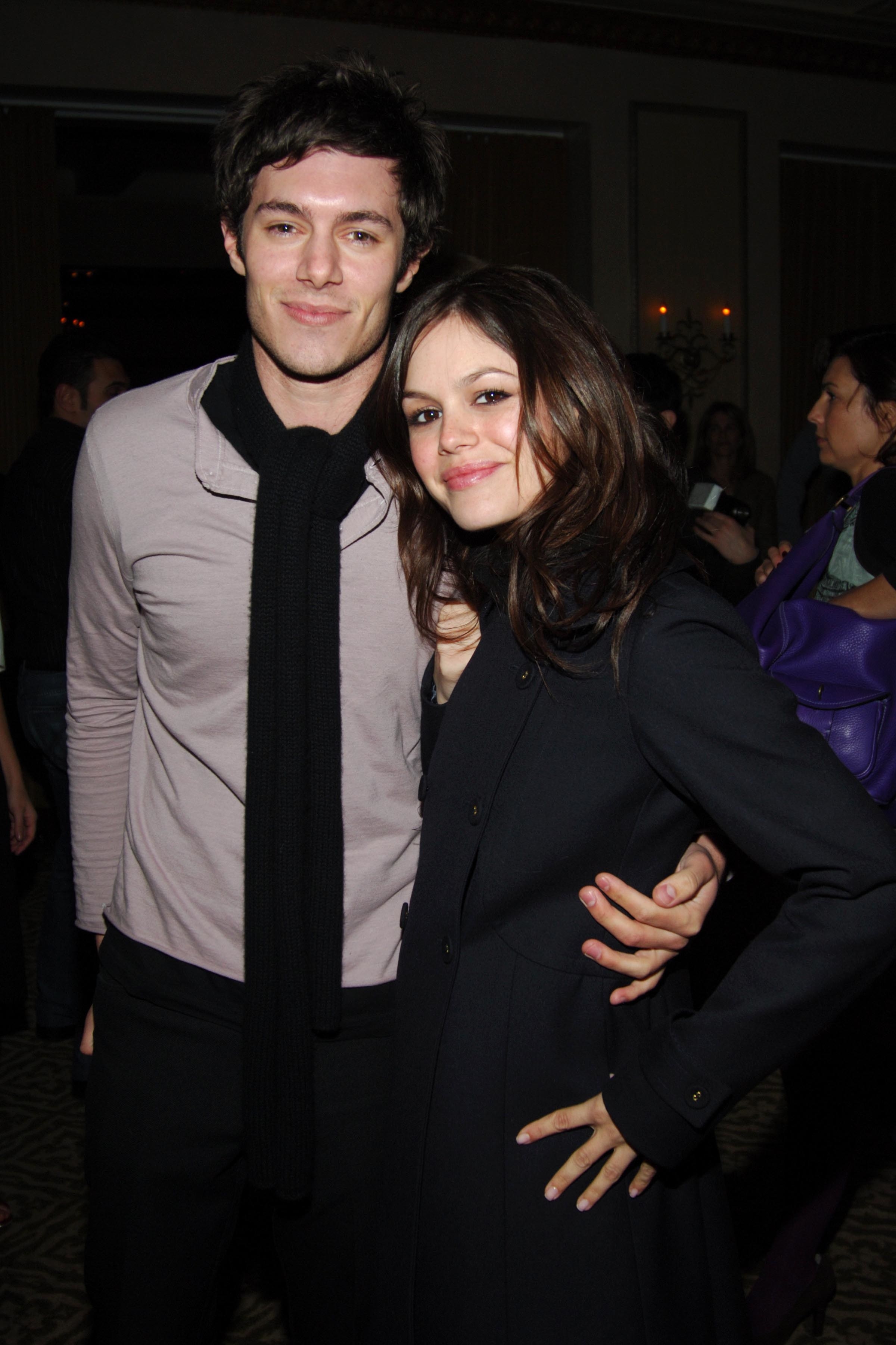 Rachel Bilson and Adam Brody hugging on the red carpet