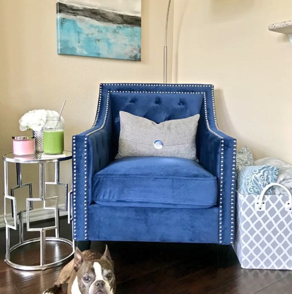 A reviewer&#x27;s marine blue, tufted armchair with nailhead trim