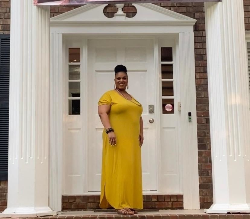 reviewer wearing the mustard colored dress