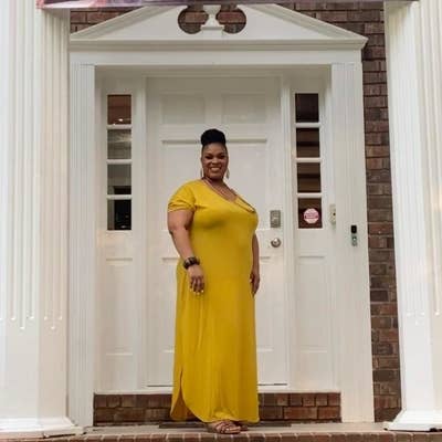 reviewer wearing the mustard colored dress