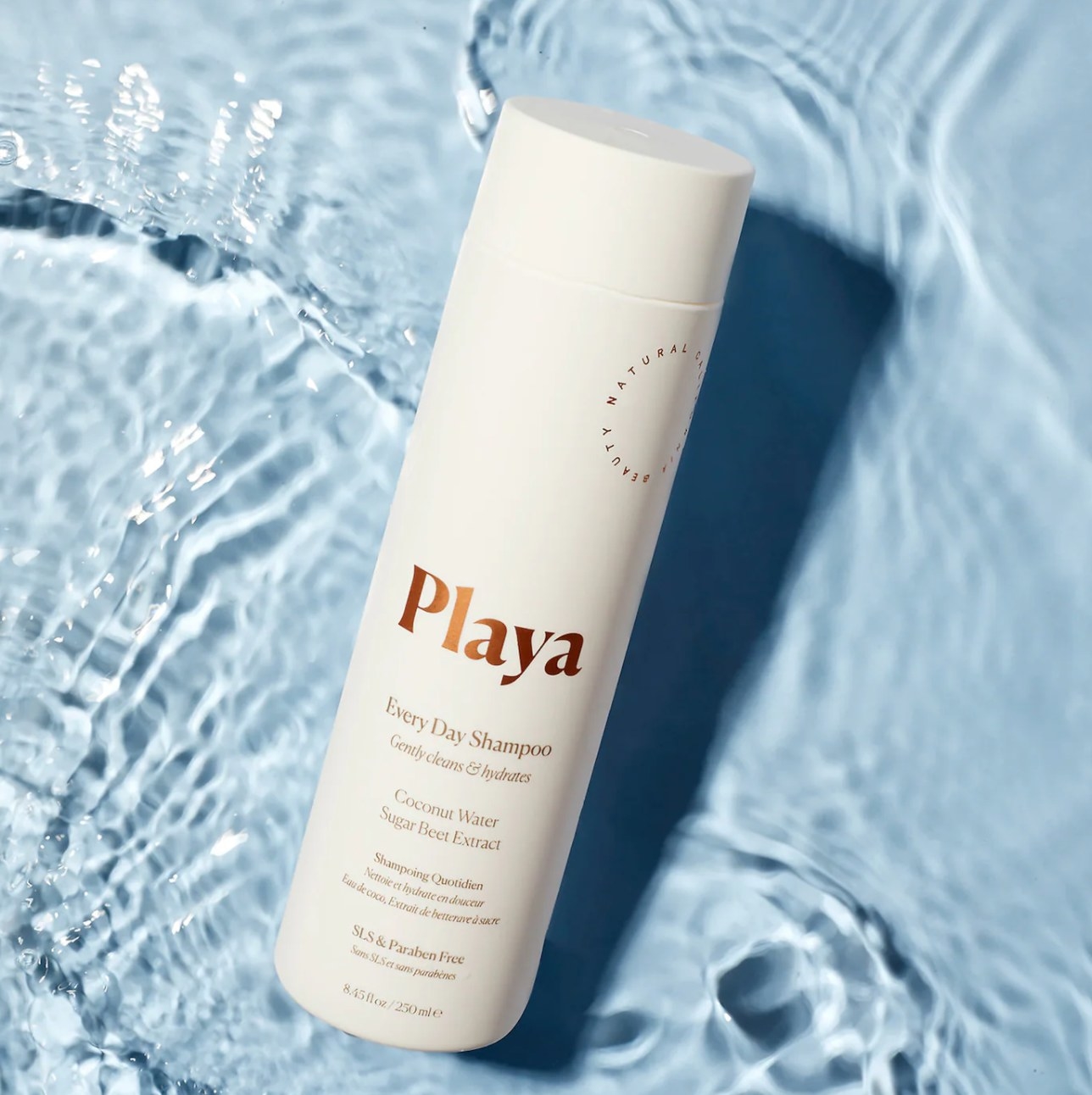 Playa everyday shampoo bottle against water