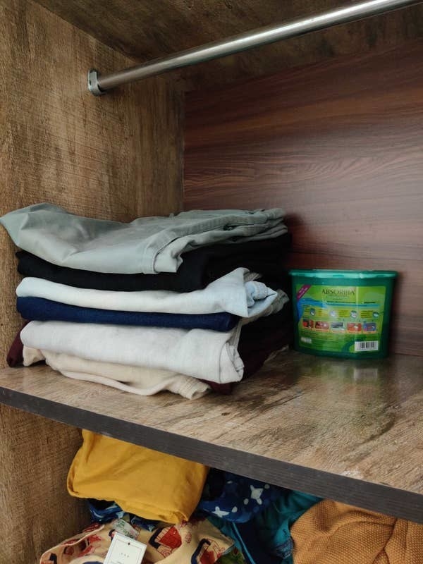A set of clothes in a wardrobe with a moisture absorber