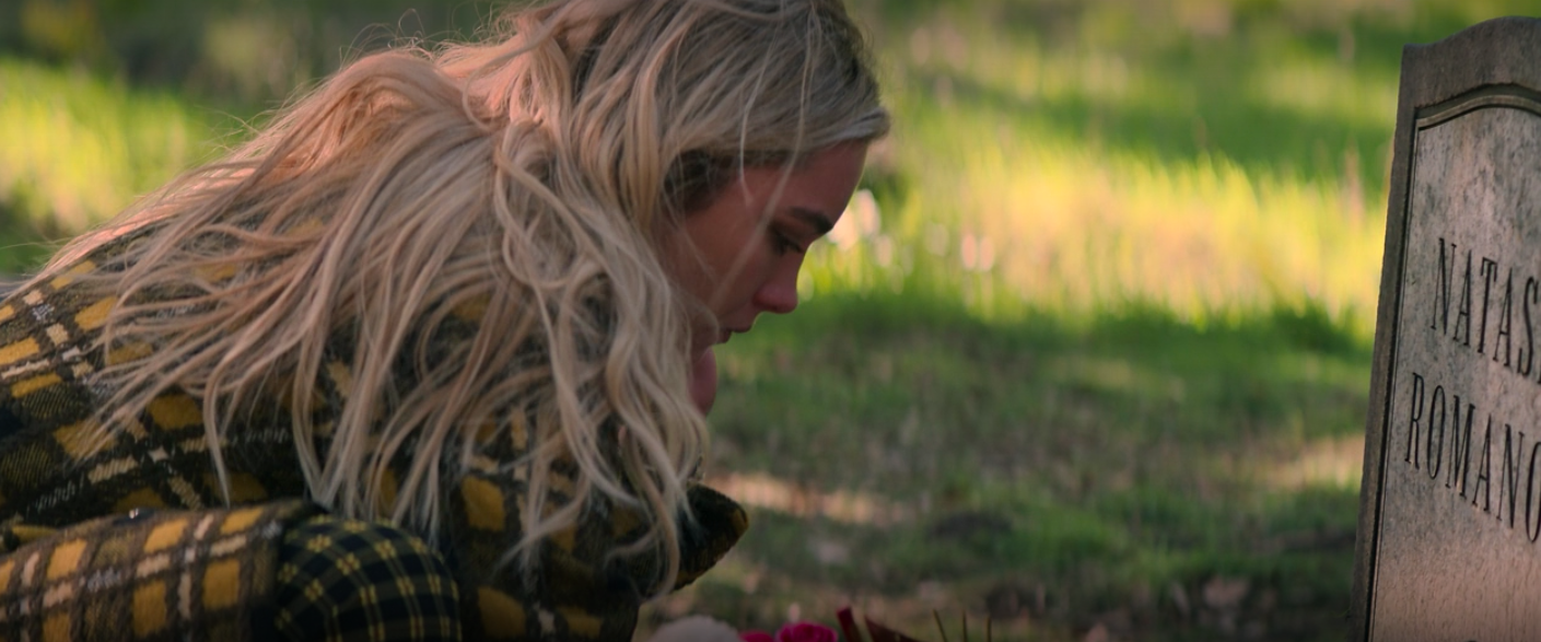 Yelena leaning over Natasha&#x27;s grave