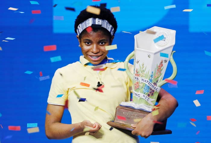 Zaila Avant-garde holds a trophy as confetti falls