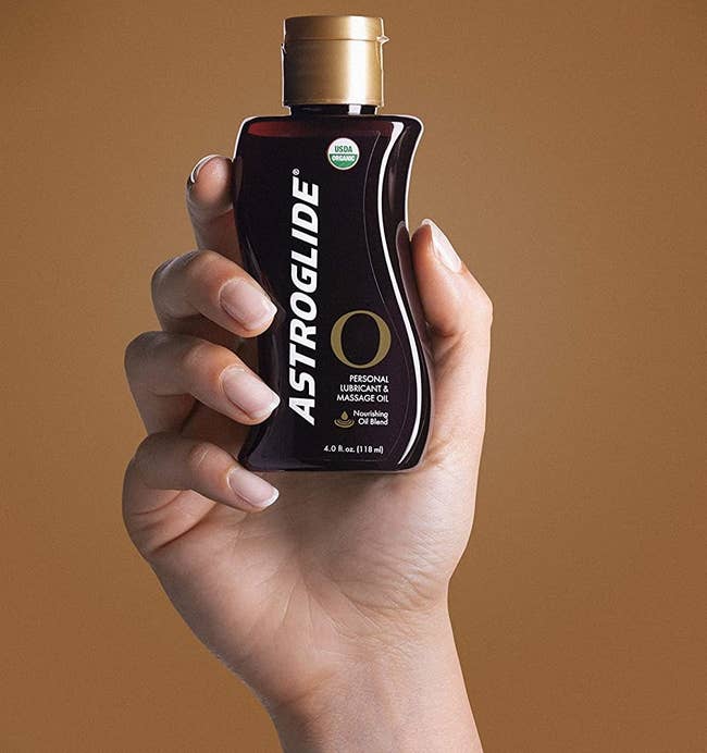 Model holding brown bottle of lubricant