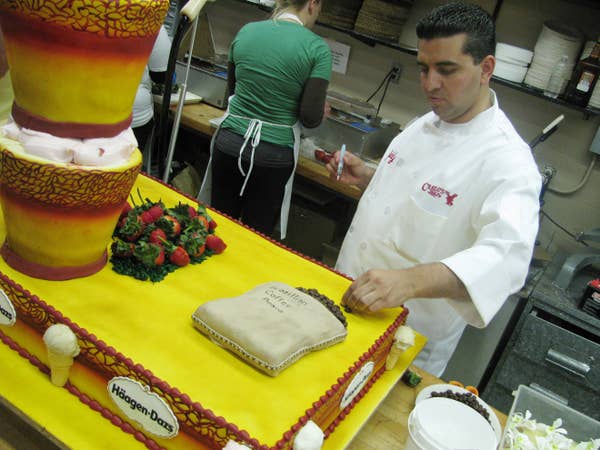 Buddy decorates a huge and elaborate cake