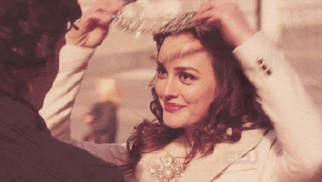 Blair Waldorf places a jeweled tiara on her head