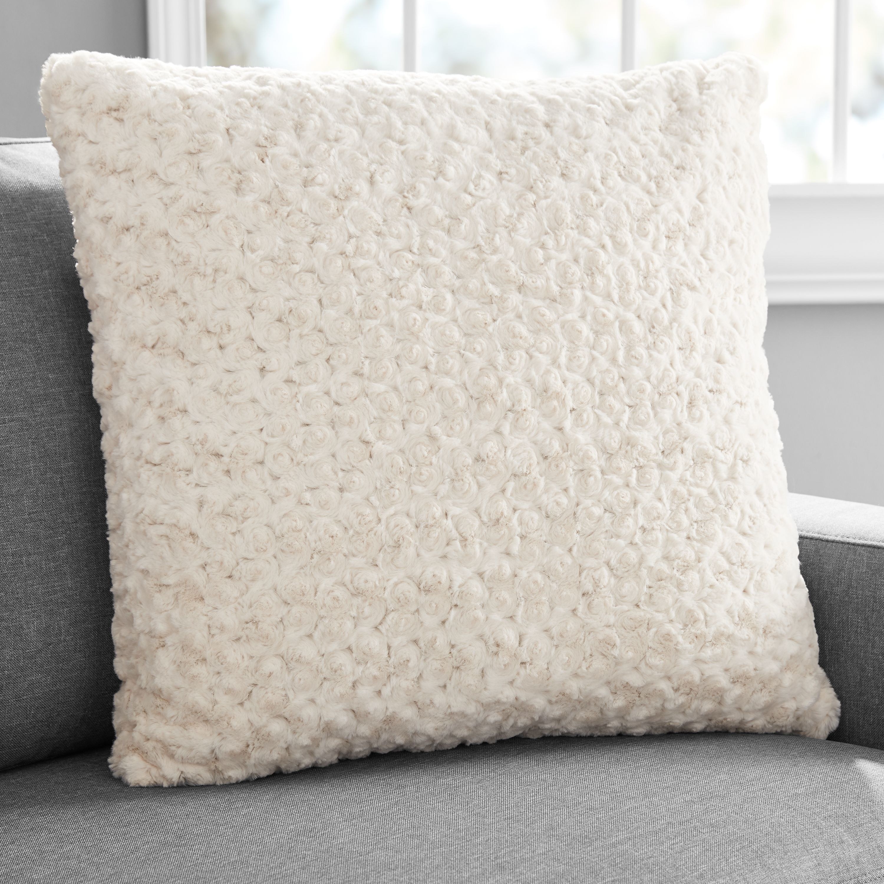 beige throw pillow on couch