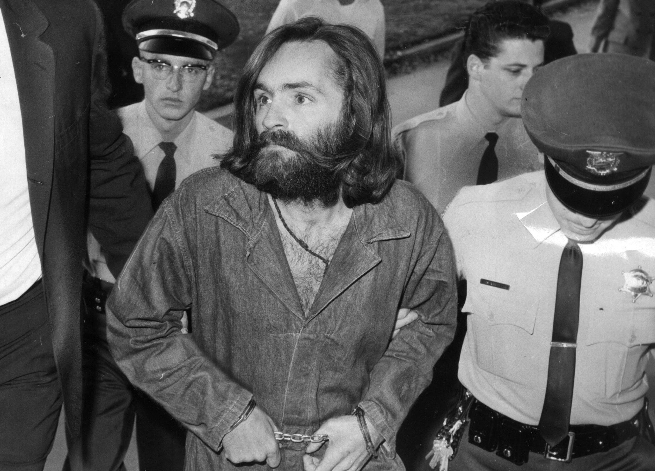 Charles Manson being escorted into prison