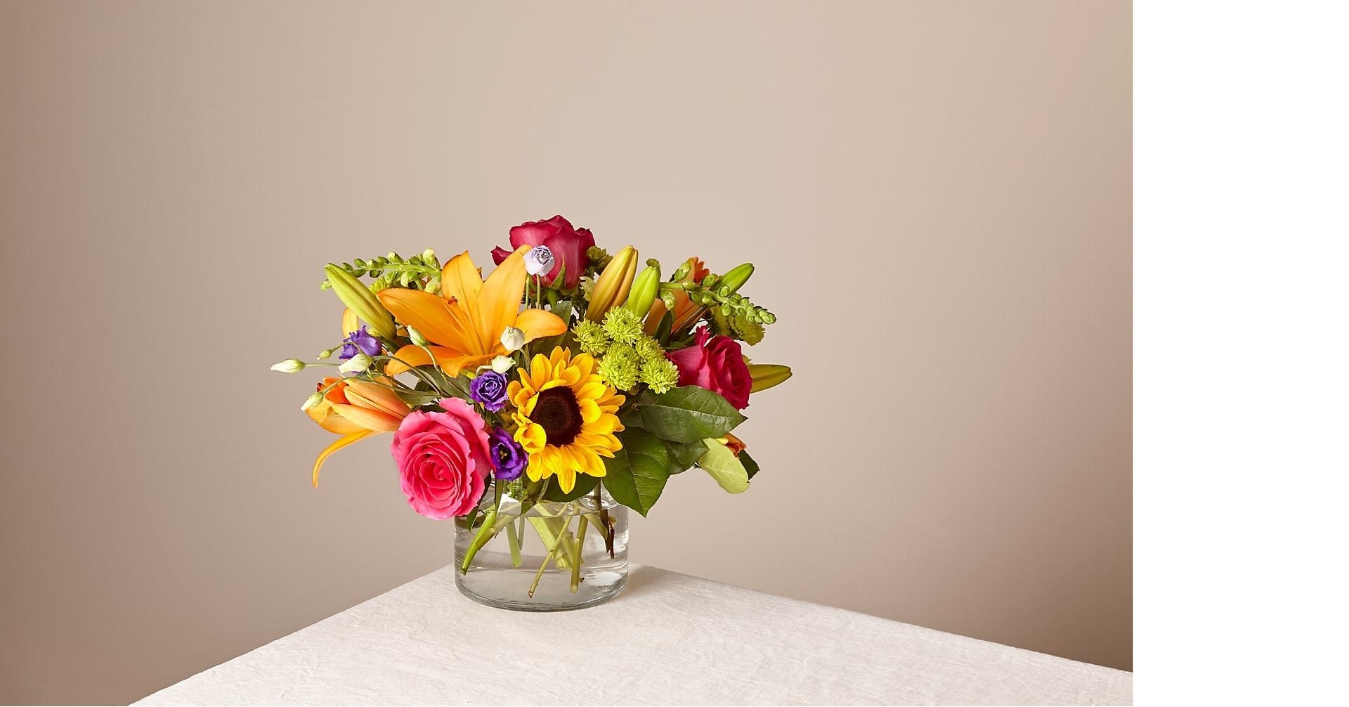 bouquet of sunflowers and roses on a marble table