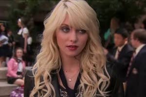 jenny humphrey with long curly hair, face relaxed except for one eyebrow cocked