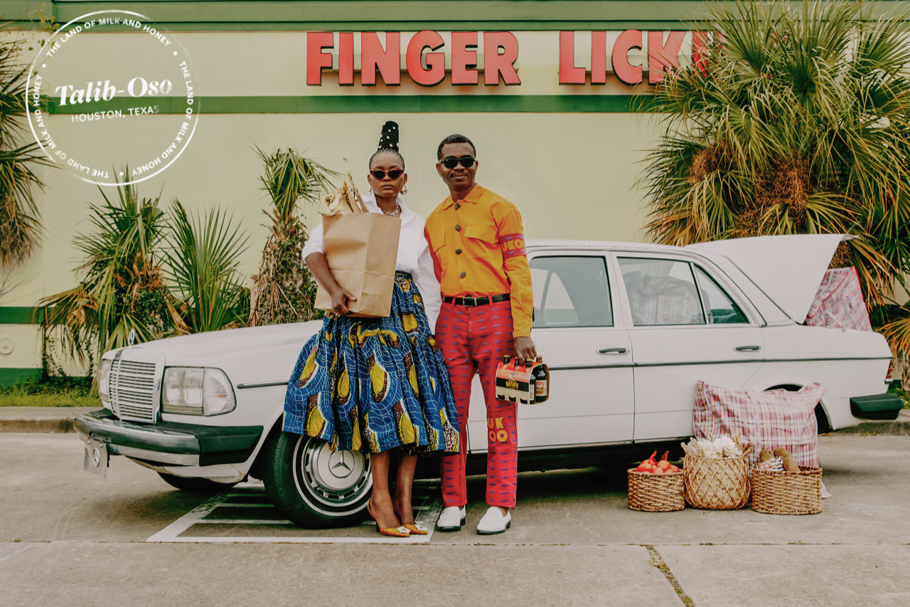 A couple stands in front of a Mercedes with grocery bags and baskets 