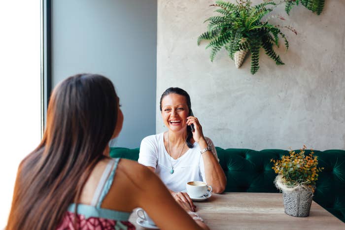 two women talking over coffee