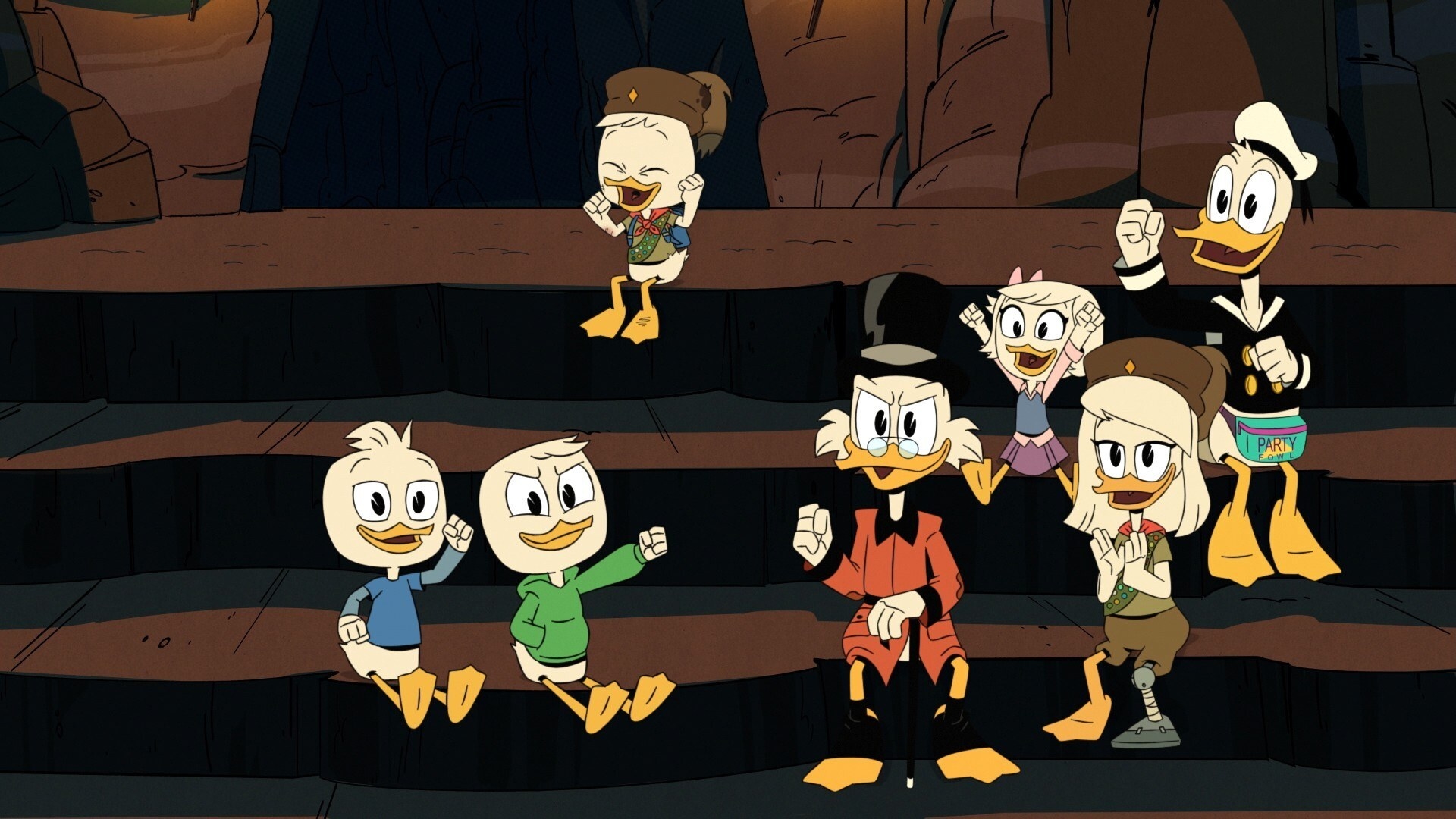 Dewey, Louie, Huey, Scrooge McDuck, Webby, Della, and Donald Duck sit on rock steps