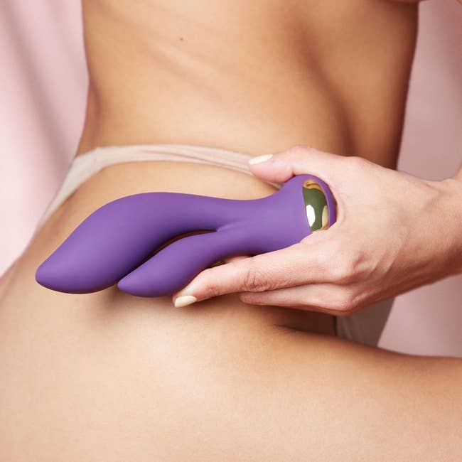 Model holding purple vibrator