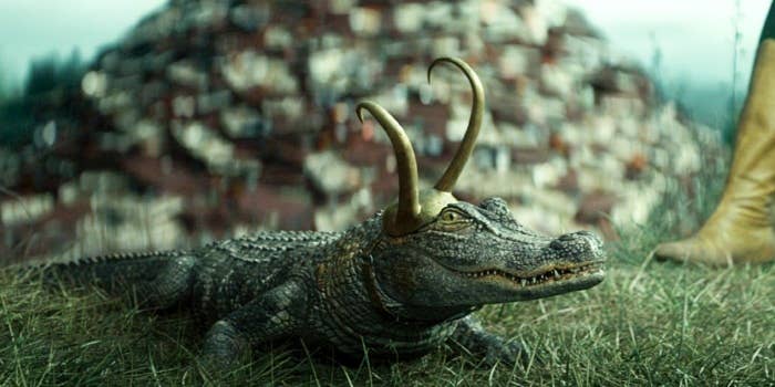 An alligator wears a double horned golden crown