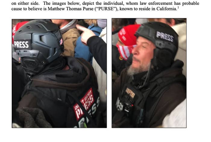 A man in tactical gear with "PRESS" written in multiple places on his back, chest, and helmet