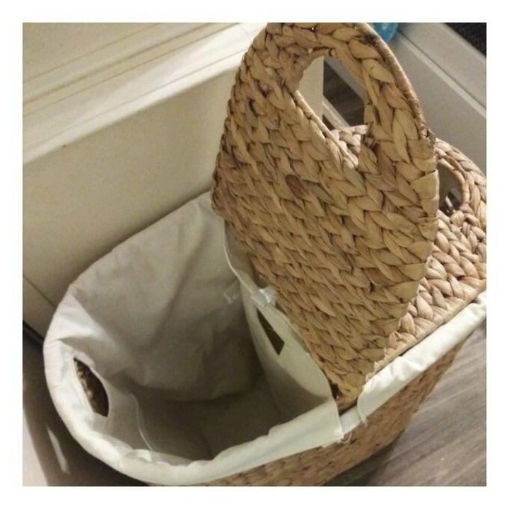 the wicker hamper with one side of its lid raised