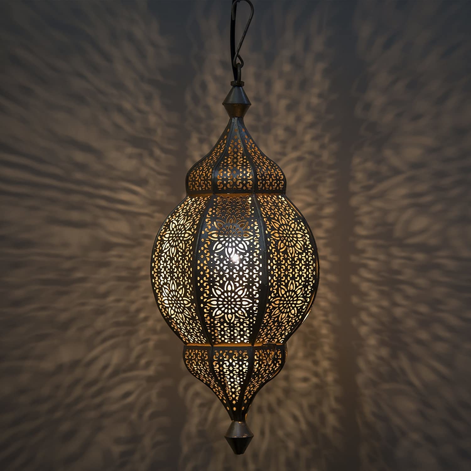 A Morrocan lamp casting shadows on the wall