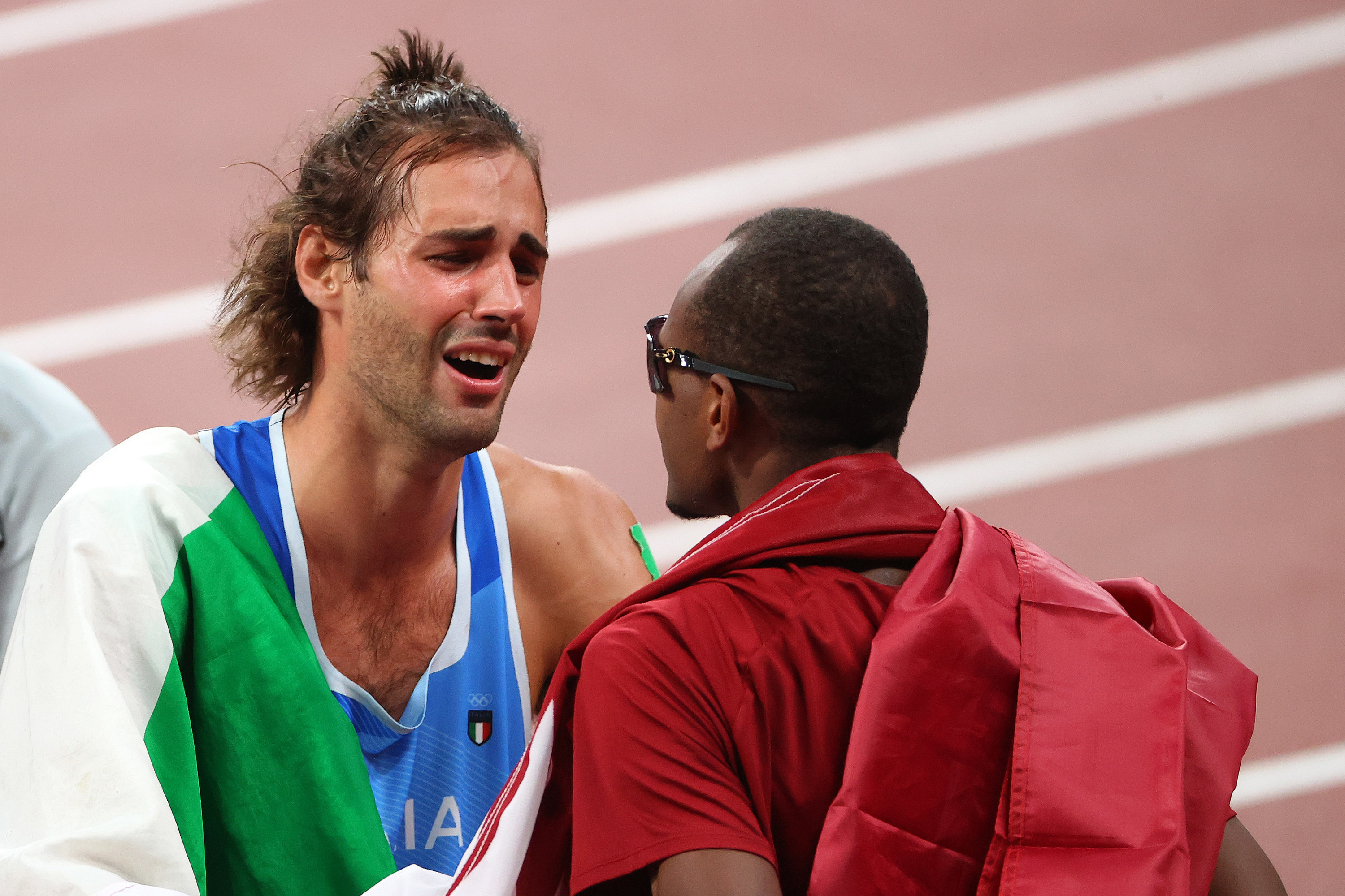 Tamberi looks emotionally at Barshim on the track