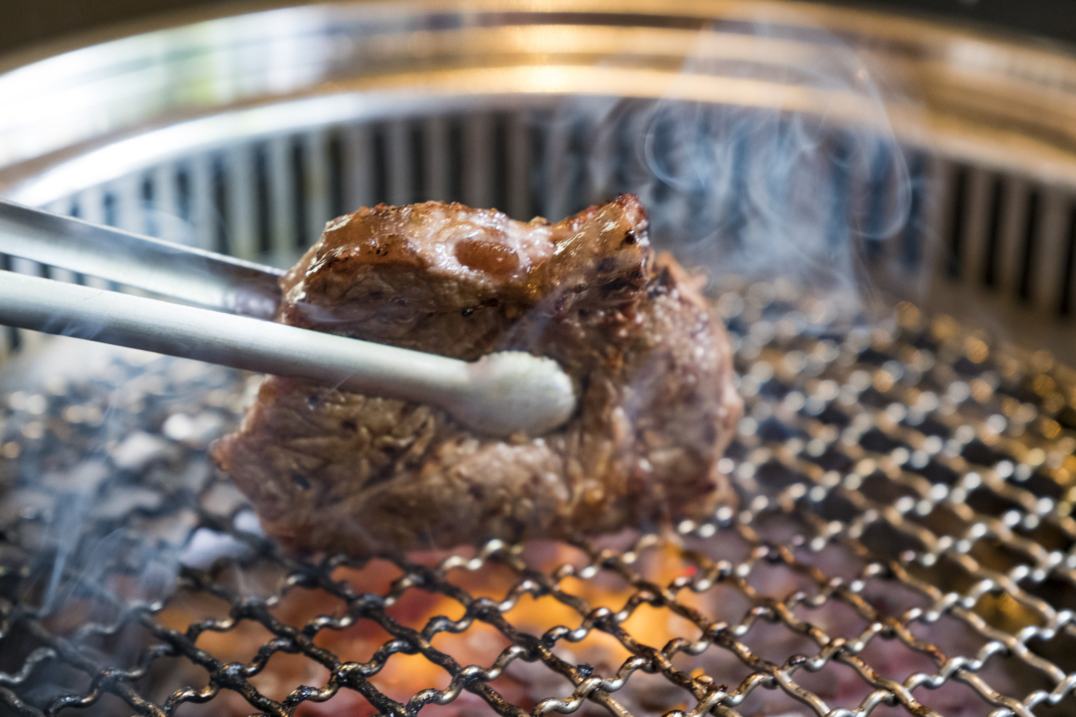 A person grilling beef