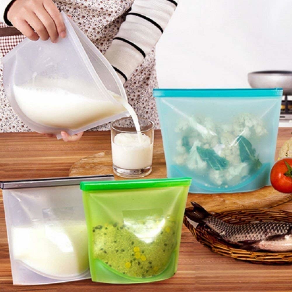 A set of storage bags with food items in them and milk being poured out of one of them