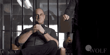Meloni sitting in an office, French doors behind him, fist-bumping another guy