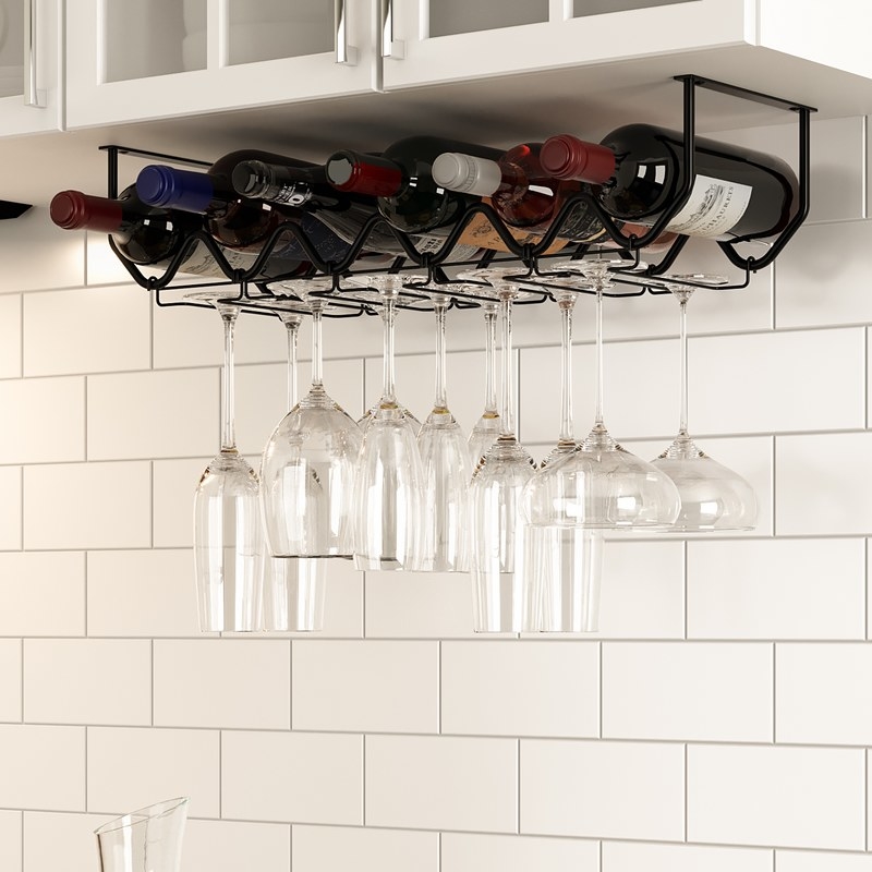Metal rack filled with bottles and wine glasses hanging in a kitchen