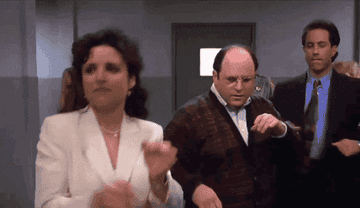 A gif of Elaine, George and Jerry dancing in the hallway of a Jail in the series finale of Seinfeld