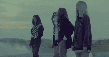 The four members of BLACKPINK standing by each other.
