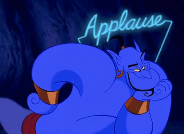 Genie from &quot;Aladdin&quot; with a neon-colored &quot;Applauses&quot; sign over his head