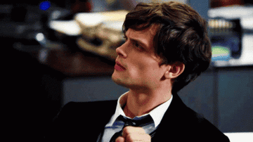 matthew gray gubler in a suit and tie, brows furrowed, mouth in a line