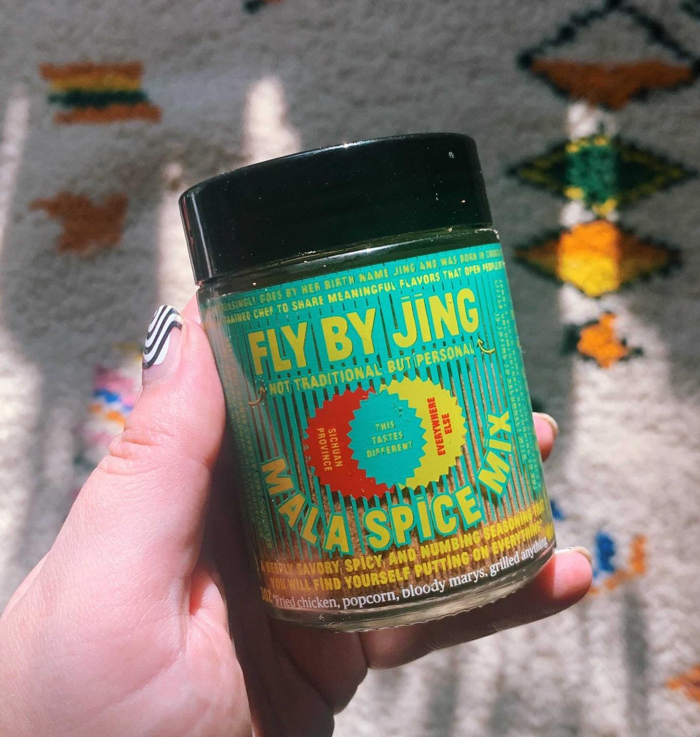 Entertainment buzzfeeder holding a jar of Mala Spice Mix