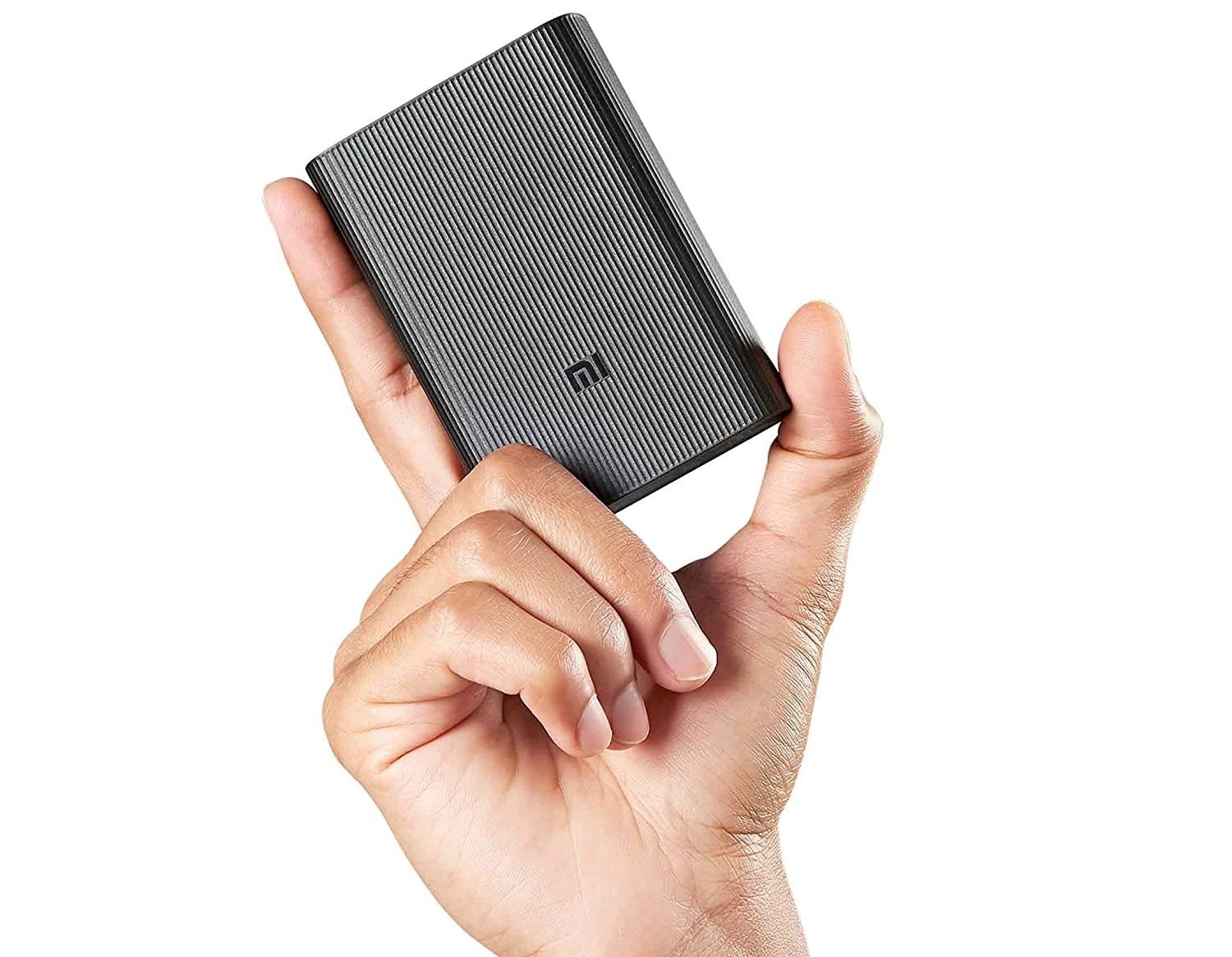 A person holding a power bank with two fingers