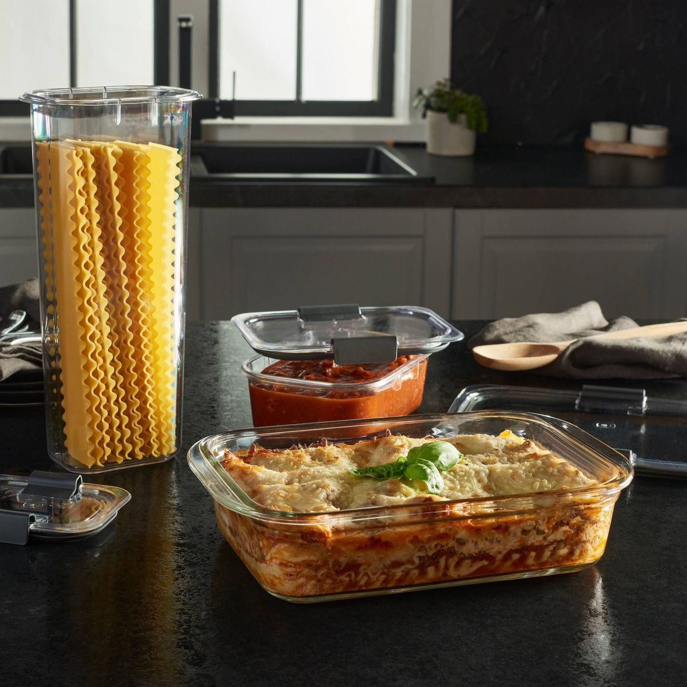 different sized glass food storage containers with food inside on a counter