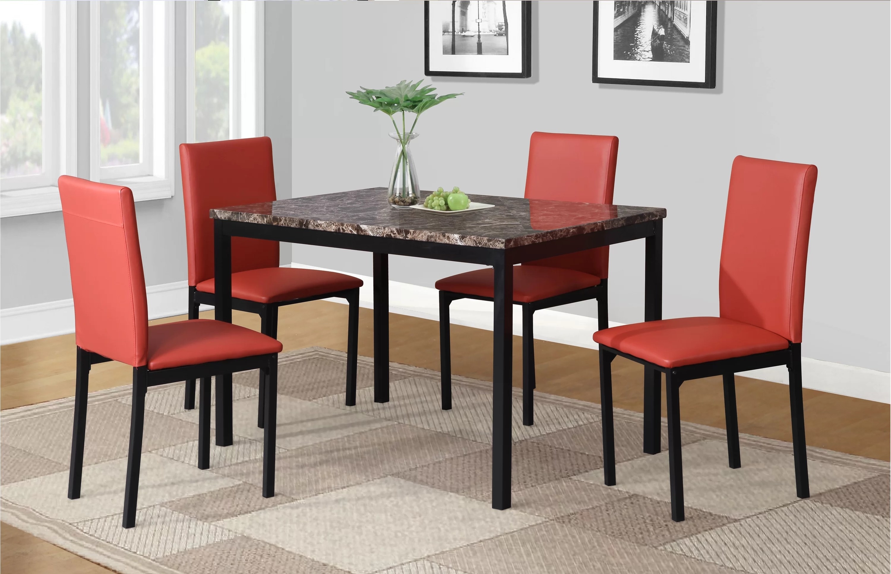 the four red fabric dining chairs and black marble table