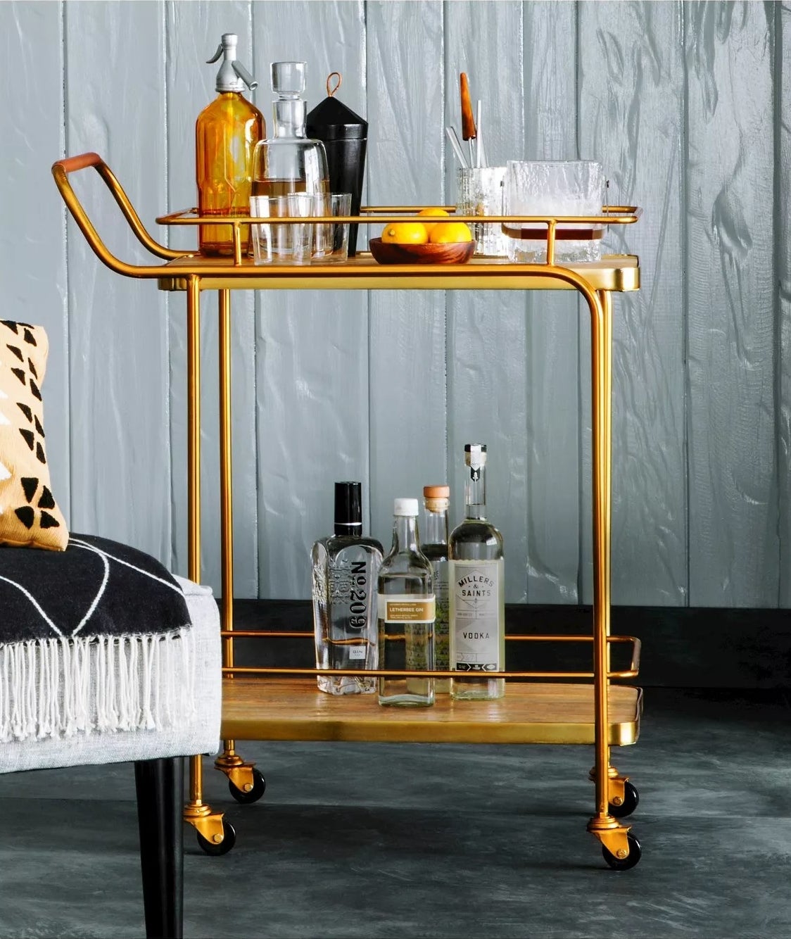 The gold bar cart with two open shelves on wheels