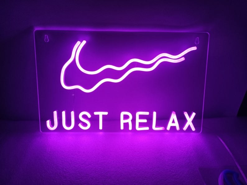 a neon sign that says &quot;just relax&quot; with a wavy Nike Check above it