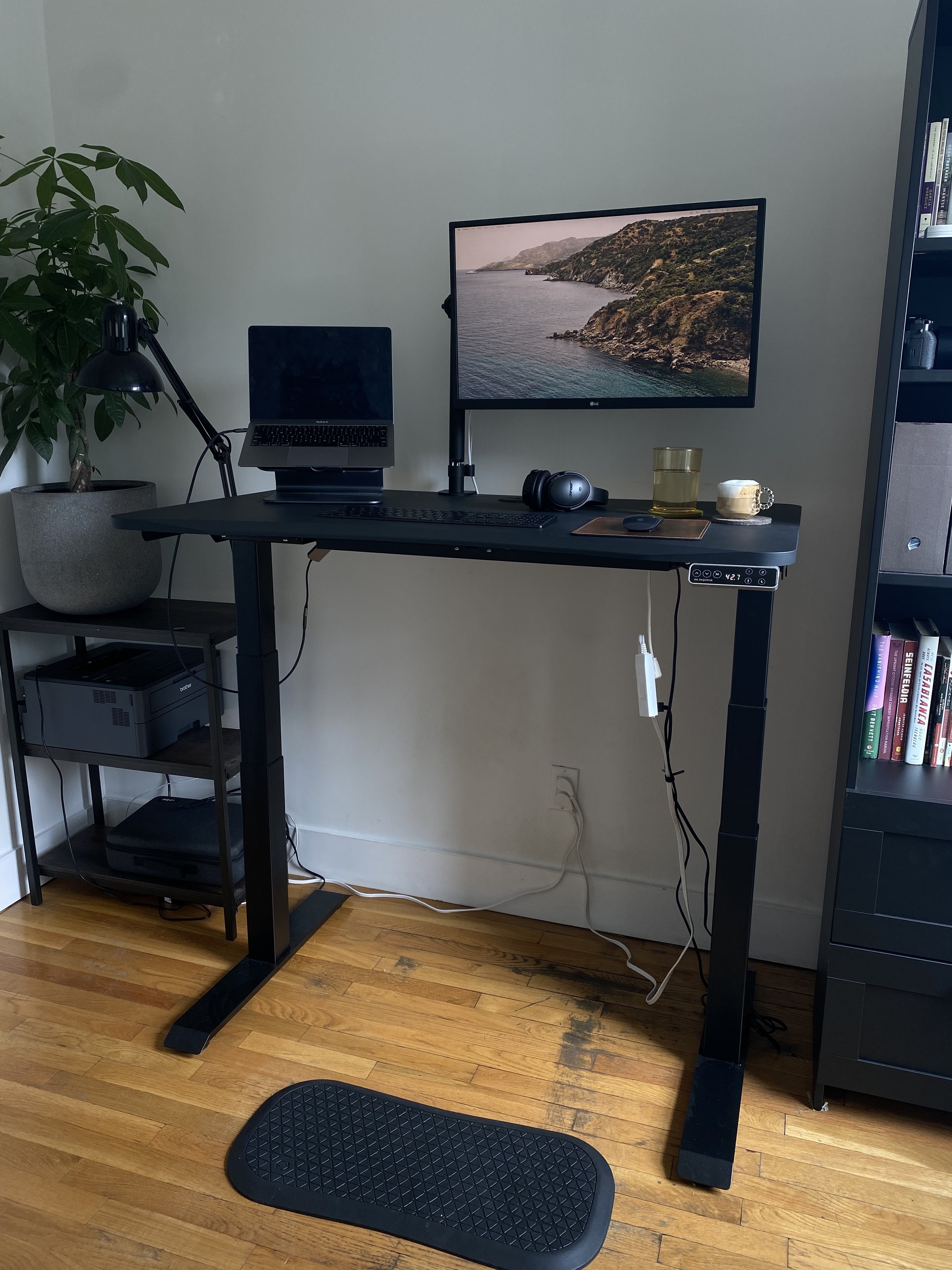 the reviewer&#x27;s image of the mat being used with the standing desk