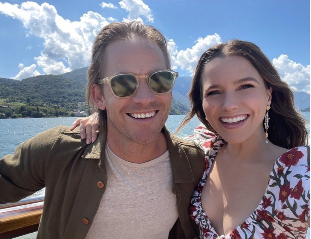 Sophia and Grant take a selfie with Lake Como and mountains in the background