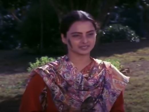 A salwar suit clad aarti smiles in a still from the movie