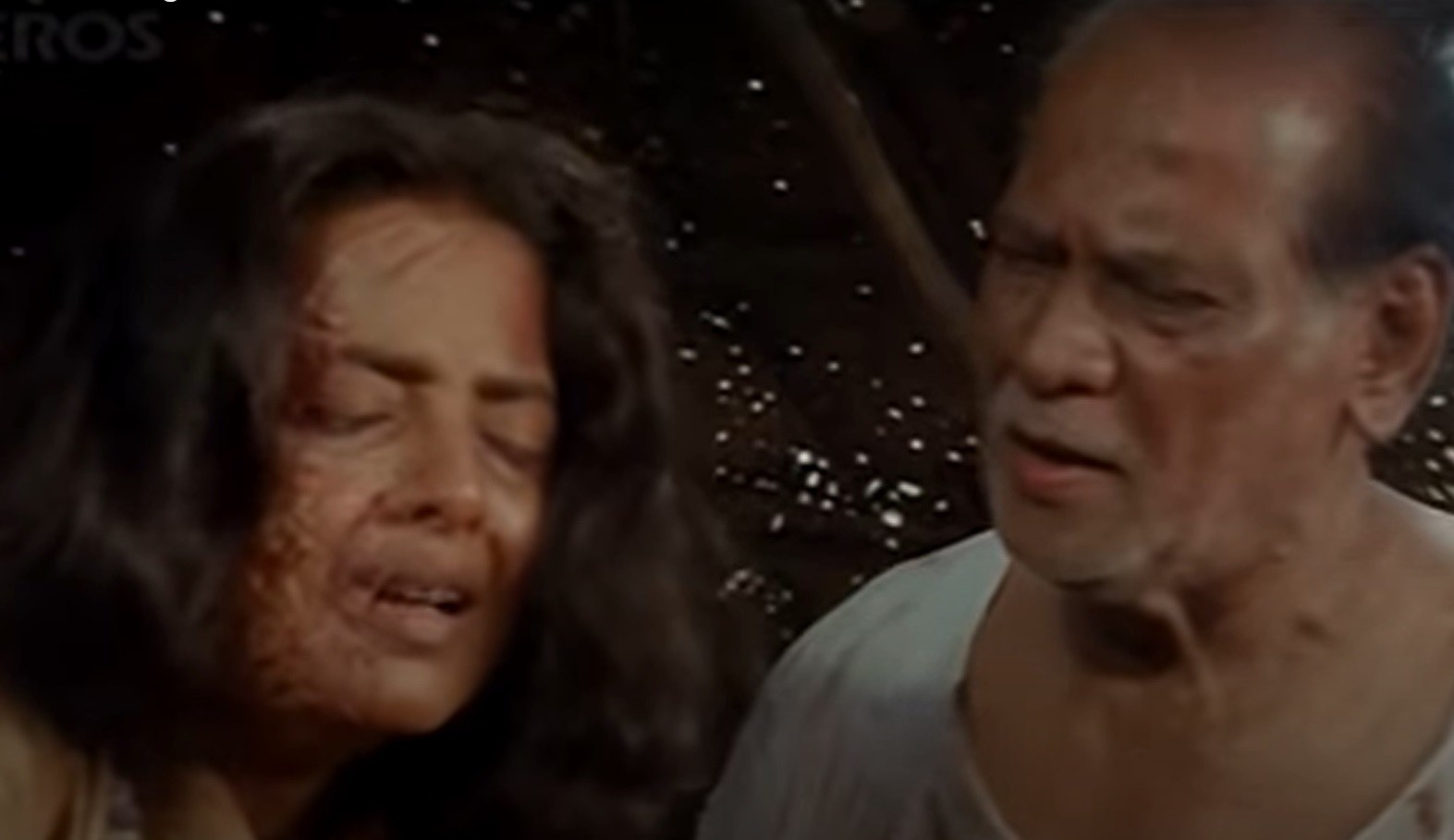 A disfigured aarti cries while the fisherman speaks to her