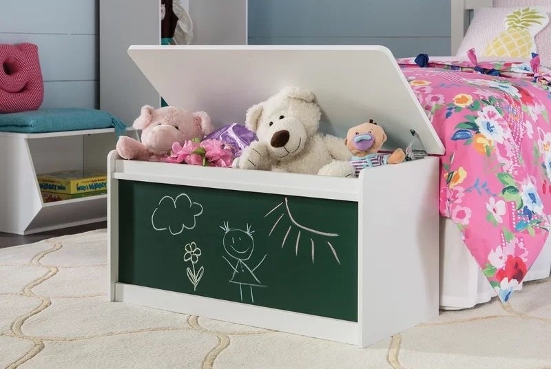 A chalkboard organizer with stuffed animals inside